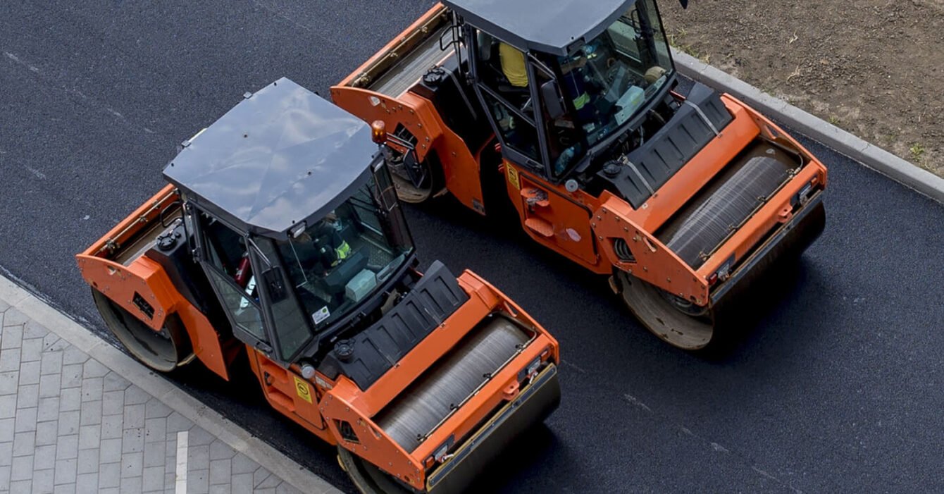 aerial-view-orange-vibratory-asphalt-roller-compactor-new-pavement (1)
